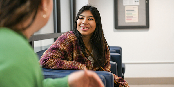 female student talking with someone at her internship site